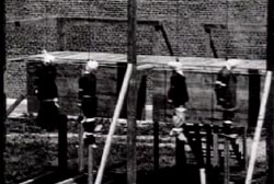 Four men hanging by their necks.