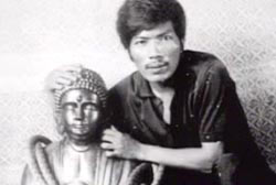 Roger Roxas with his arm around a statue of a Buddha