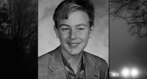 Russell Evans smiling, trees on side