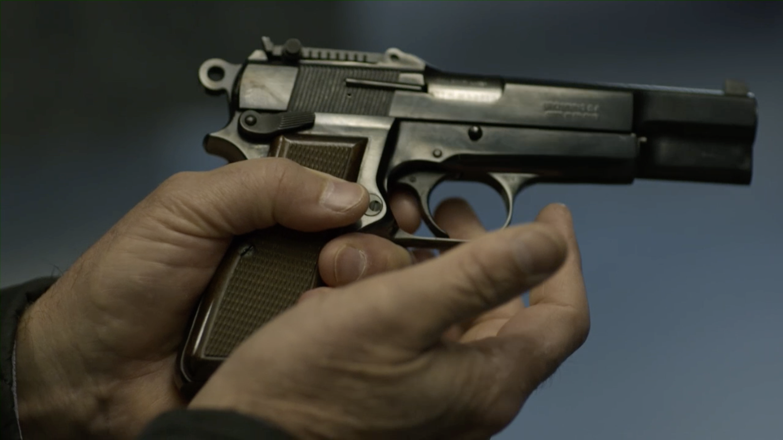 Two hands holding a gun