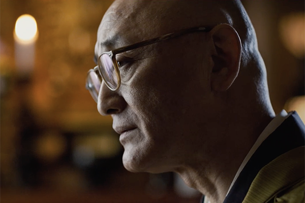 Buddhist reverend looks to the left