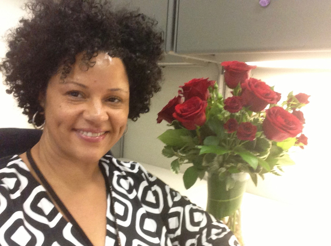 Alicia Griffin, smiling with roses