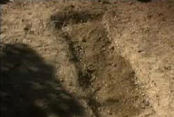 A partially excavated grave.
