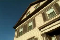A three story house, light yellow.