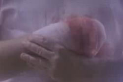 A person holding their right arm, that has been amputated at the wrist, with their left hand.