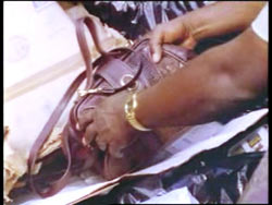 A brown leather purse is found in a dumpster.