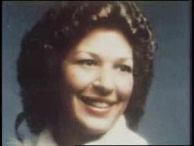 A caucasian woman with short tight curly dark brown hair, Cynthia Anderson.