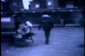An image for a security camera, a man in a mask walking through a lobby.