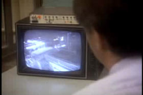A police officer watching security footage.