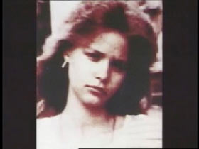 A young caucasian woman with feathered brown hair, Suzanne.