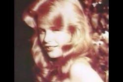 Suzanne posing in the sun with her hair down.