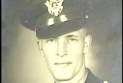 A caucasian man, Ray Hickenbotham, wearing a military uniform. His hat covers his hair.
