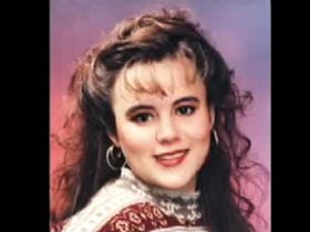 A young caucasian woman, Star Palumbo, with long brown hair and bangs posing for a school photo.