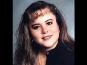 Star Palumbo in her mid 20s, she is wearing a blue button up shirt.