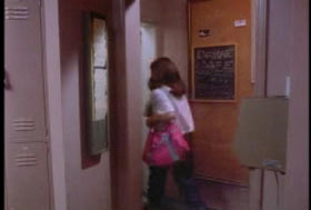 A young woman with a pink backpack walking out of a workplace.