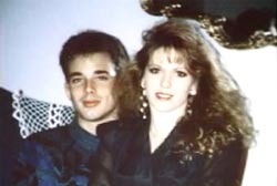 Tara Breckenridge is sitting on her boyfriend's lap, Wayne. He is a caucasian man with short brown hair