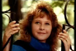 Smiling Jodie Bordeaux in a blue turtle neck