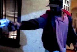 Suspect in a hat aims his gun at someone