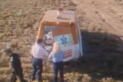 Paramedics putting the covered body of Reynaldo into the back of an ambulance