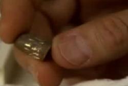 a man holding a small bullet