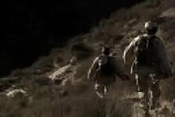 Two people hiking across a desert