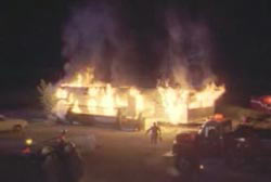 Firefighter rushing to the Hansen home as its engulfed in flames