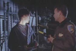 A police officer shining a light on Donnie