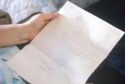 a person holding an un folded letter 
