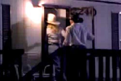 A man and a woman wearing cowboy hat entering a trailer