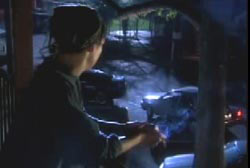 Megan's neighbor sitting on the stoop of her apartments watching a car drive away