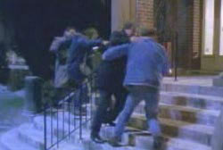 A group of people walking up the steps of a court house