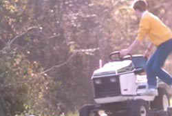 A man steping down from a white tractor