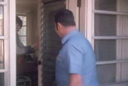 A woman opening the door to Permon Gilbert