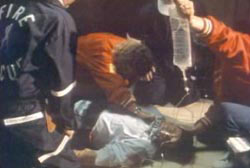 Paramedics crowded around Steve attempting CPR