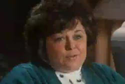 Smiling Georgia Rudolph with dark hair 