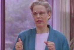 Smiling Nany Myer in a blue robe with glasses