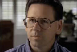 Bruce Kelly wearing glasses