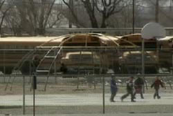 4 children playing in the playground of a school