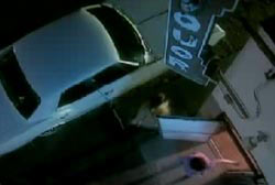 A person runnin gout of a liqour store to a car parked outside