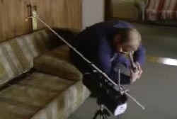 Crime scene analyst measuring the trajectory of bullet to rule out suicide