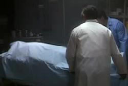 Medical examiners covering the body of Jayson Artis