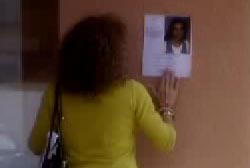 Tammy looking at a flyer for Natasha Jennings