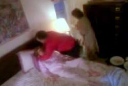 Patsy's family attempting to resuscitate her while she lays in bed