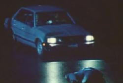 A car stopped in front of Russels body in the middle of the street