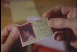 Someone holding Tommy's drivers license