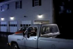 Pickup truck parked outside of an apartment at night