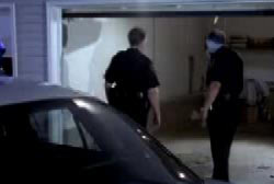 Police looking inside of an empty garage