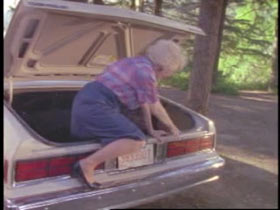 Opal climbing out of the trunk of the car