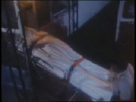 paramedics wheeling out the covered body of Charlie Sigmin on a strecher