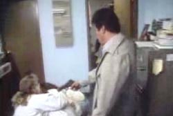 Man holding a gun up to two witnesses cowering on the floor